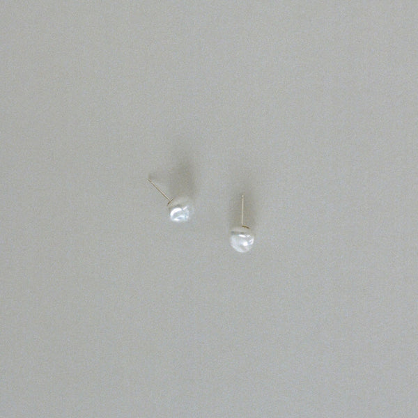 Pearl stud earrings handmade in London, UK, with freshwater keshi pearls. Made using ethical processes, with 14k gold or sterling silver posts.